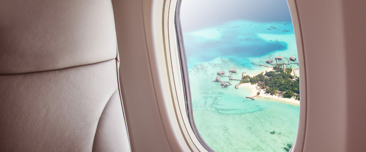 Caribbean ocean view with white sand out an airplane window